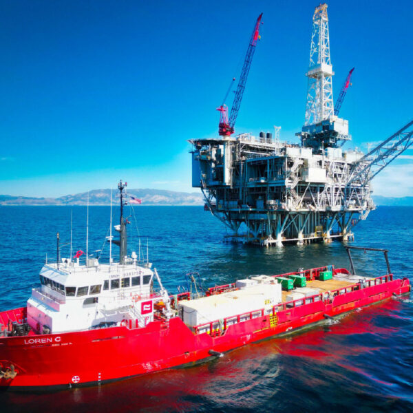 An offshore vessel is pictured, anchored near a fixed offshore platform