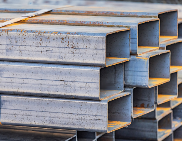Stacked structural steel sections prepared for fabrication with controlled material traceability processes.